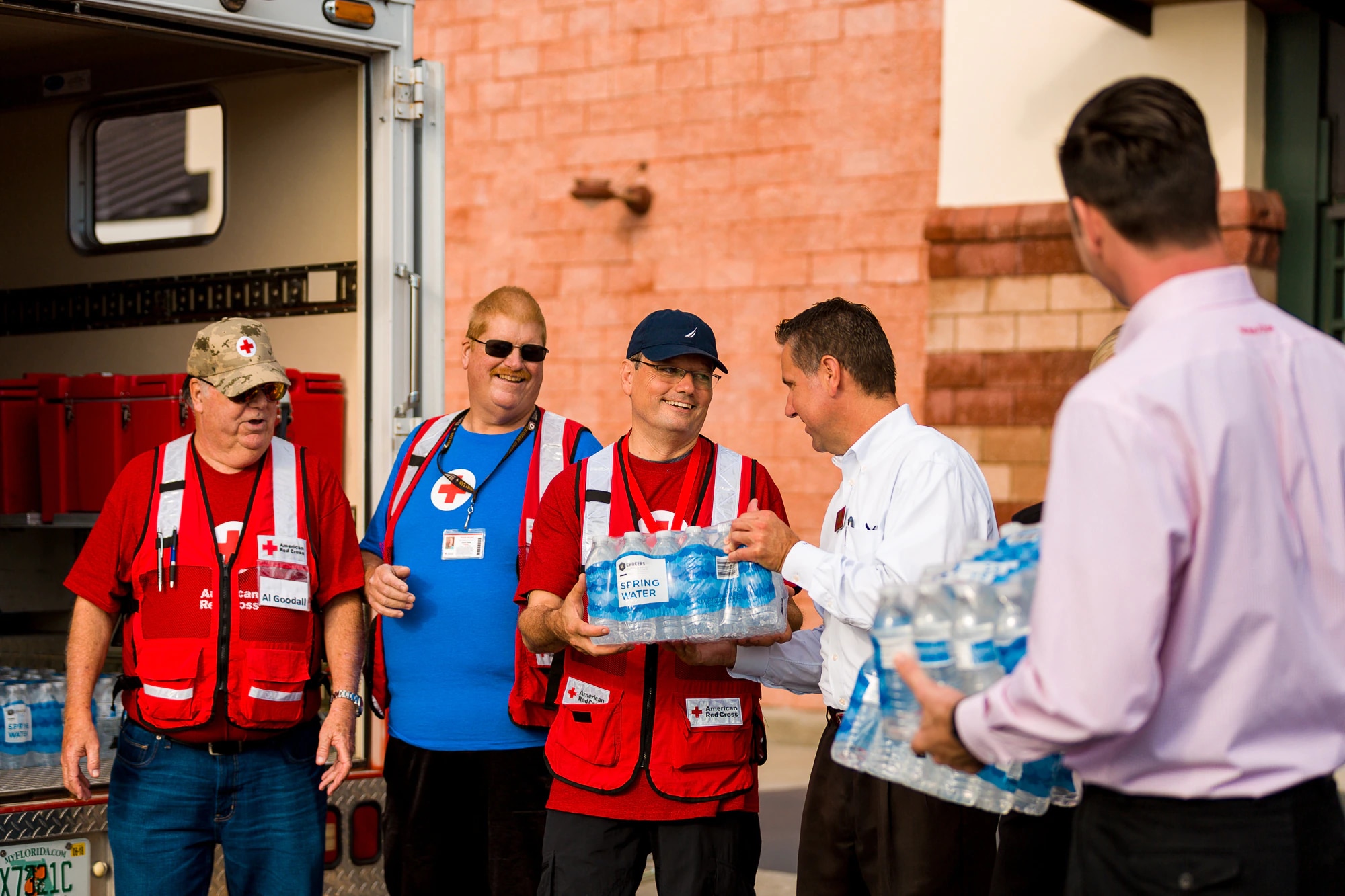 Winn-Dixie associates help the Red Cross load waters into truck