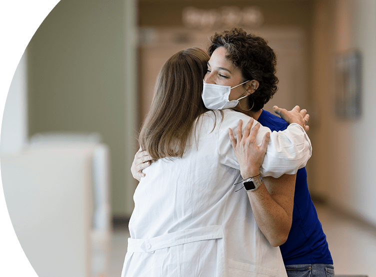 Two physicians joyfully embracing. 