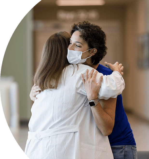 Two physicians joyfully embracing. 