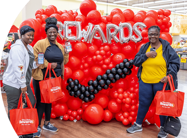 Winn-Dixie employees smiling with bags of groceries