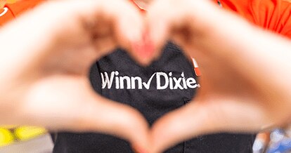 Winn-Dixie employee making a heart gesture with their hands