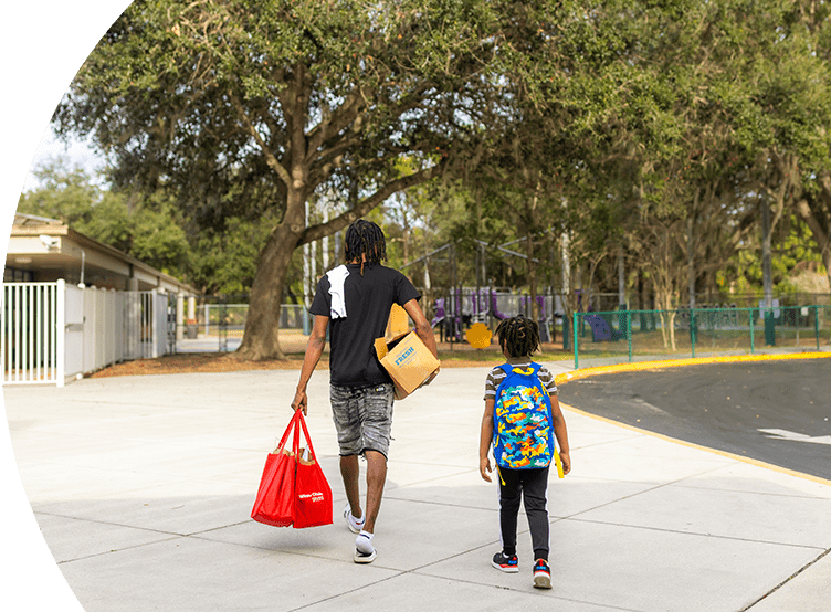 Dad and son carrying Winn-Dixie groceries.