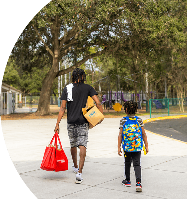 Dad and son carrying Winn-Dixie groceries.