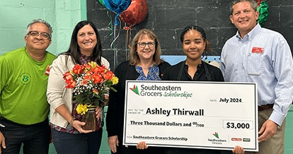 SEG intern and scholarship winner showcasing $3,000 reward.
