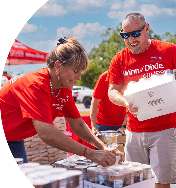 Winn-Dixie gives foundation volunteers assembling packages of canned goods for donation.
