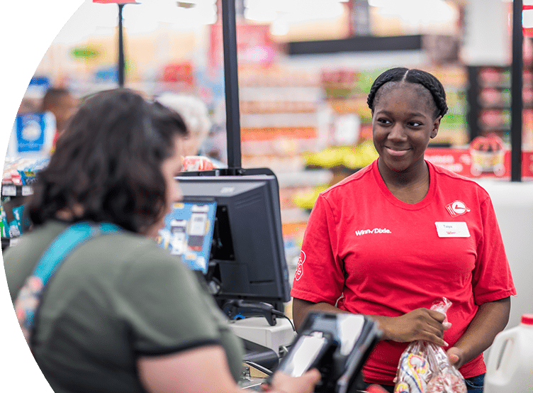 Winn-Dixie cashier checking out groceries for customer.