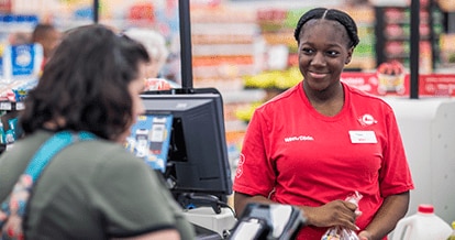 Winn-Dixie cashier checking out groceries for customer.
