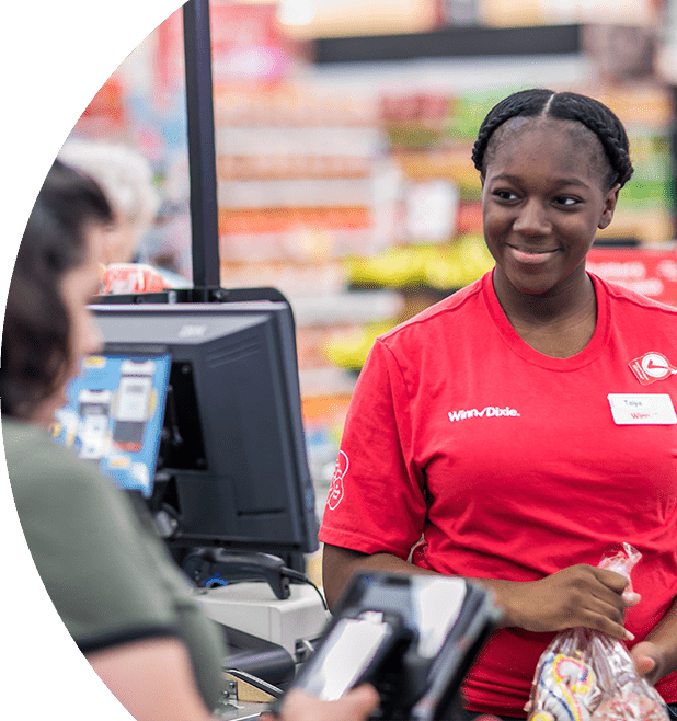Winn-Dixie cashier checking out groceries for customer.