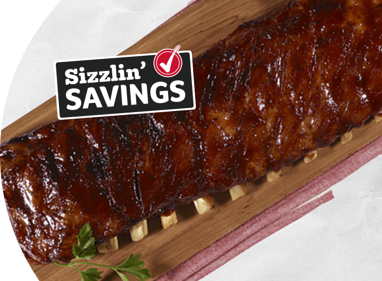 Rack of ribs on a grey background. Text that reads Sizzlin' Savings with a Winn-Dixie check mark