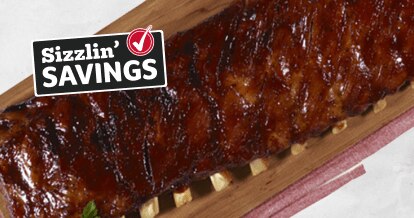 Rack of ribs on a grey background. Text that reads Sizzlin' Savings with a Winn-Dixie check mark