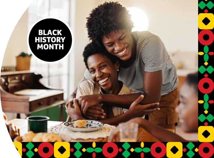 A couple hugging and smiling around the dinner table