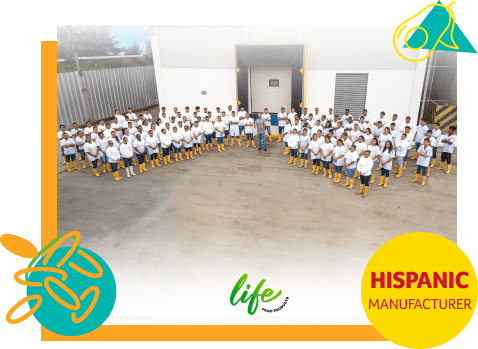 Group of Life Foods employees in white coats outside of their factory.