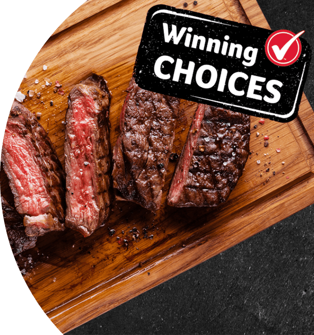 Cooked meat cut into pieces placed on a wooden board. 