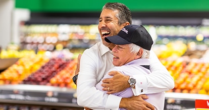 Two Winn-Dixie employees hugging and smiling