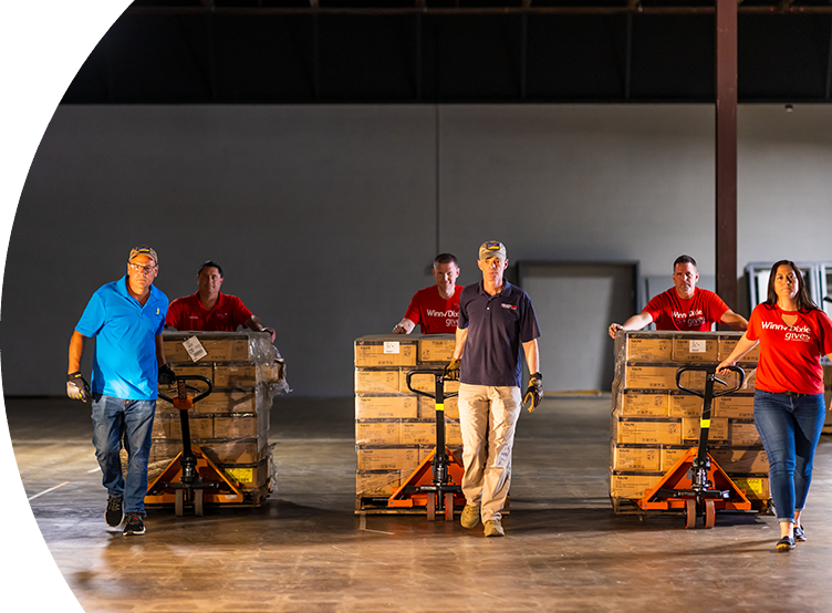 Workers pulling merchandise carts