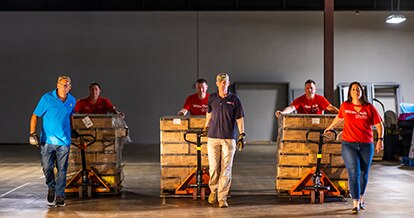 Workers pulling merchandise carts