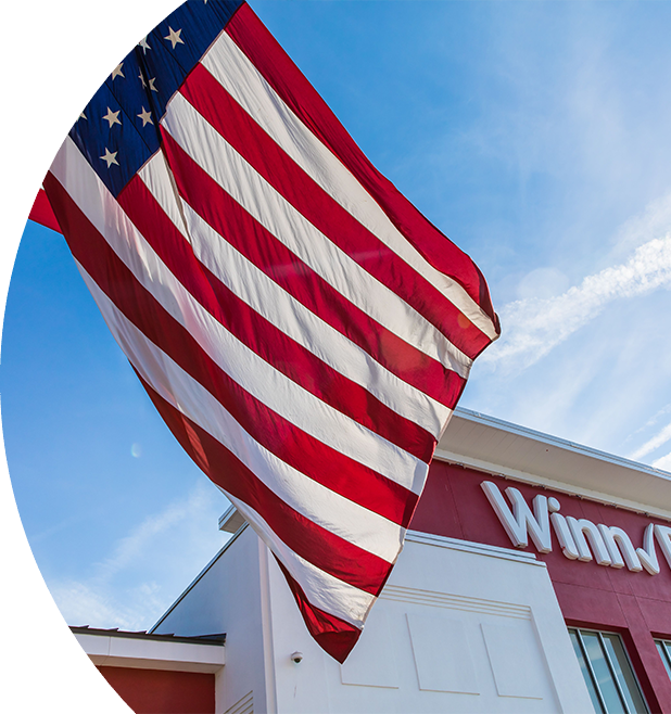 Winn-Dixie storefront with American flag waving out front. 