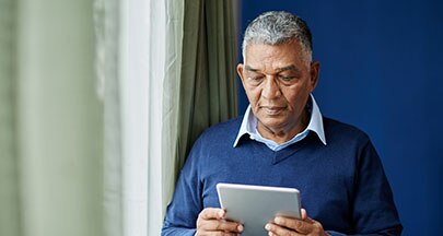Man scrolling on tablet